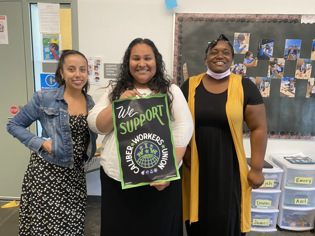 Members of the Caliber Workers Union in a classroom showing support for their union